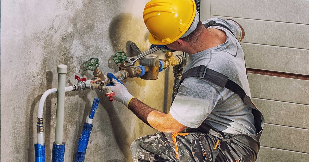 plumber fixing pipes